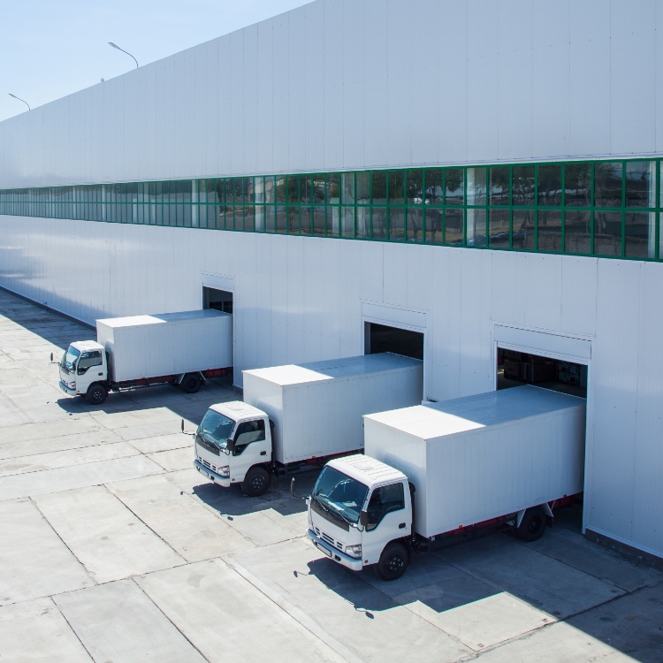facade of an industrial building and warehouse with freight cars in length
