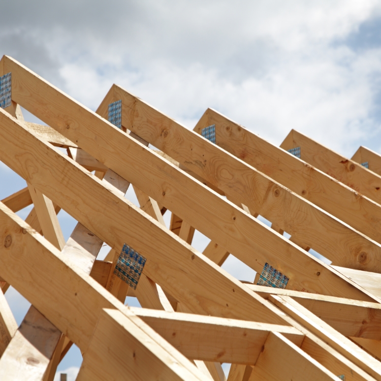 Construction of a wooden roof frame underway