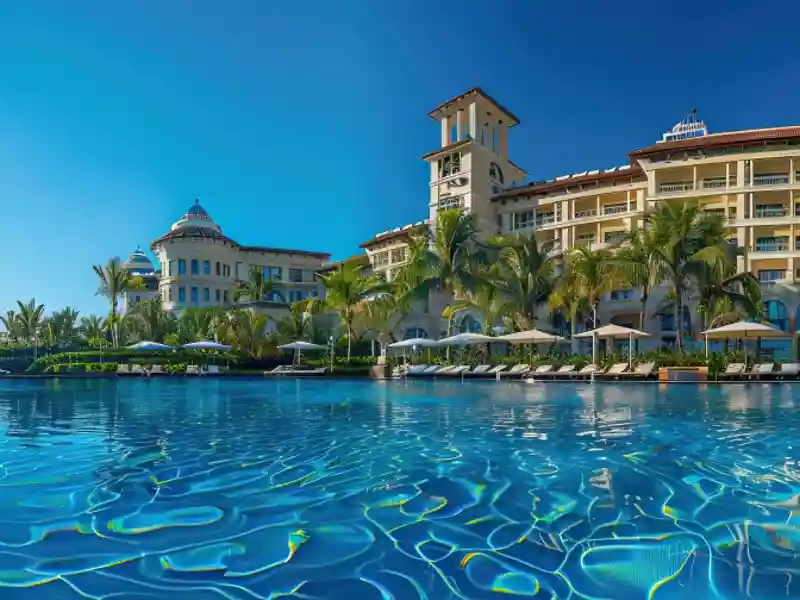 Large resort on the water with blue, sunny skies.