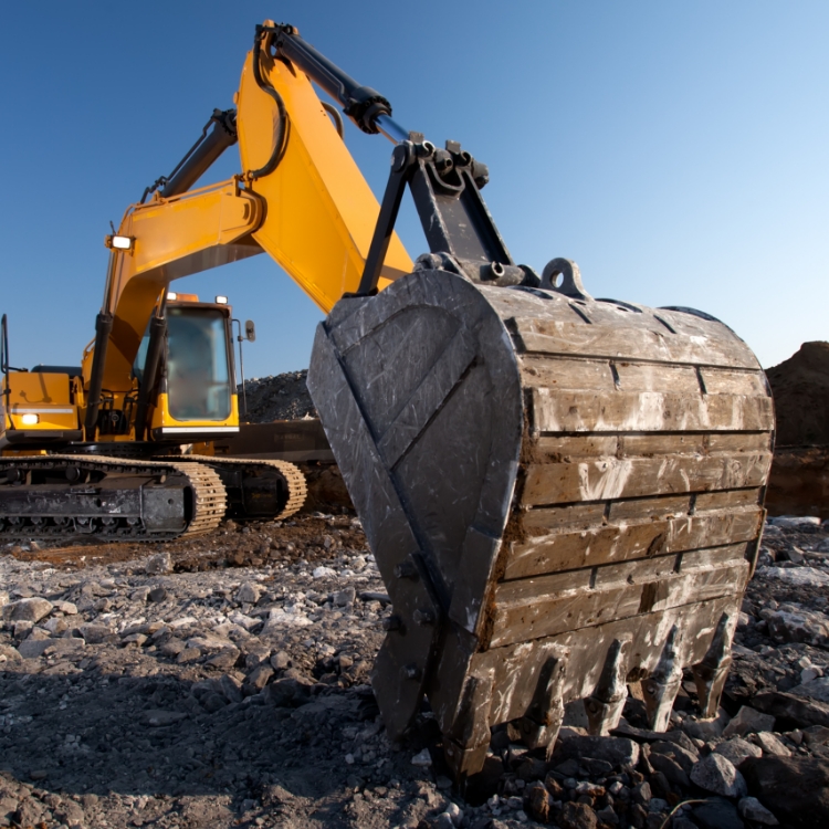 yellow escavators working on a mine