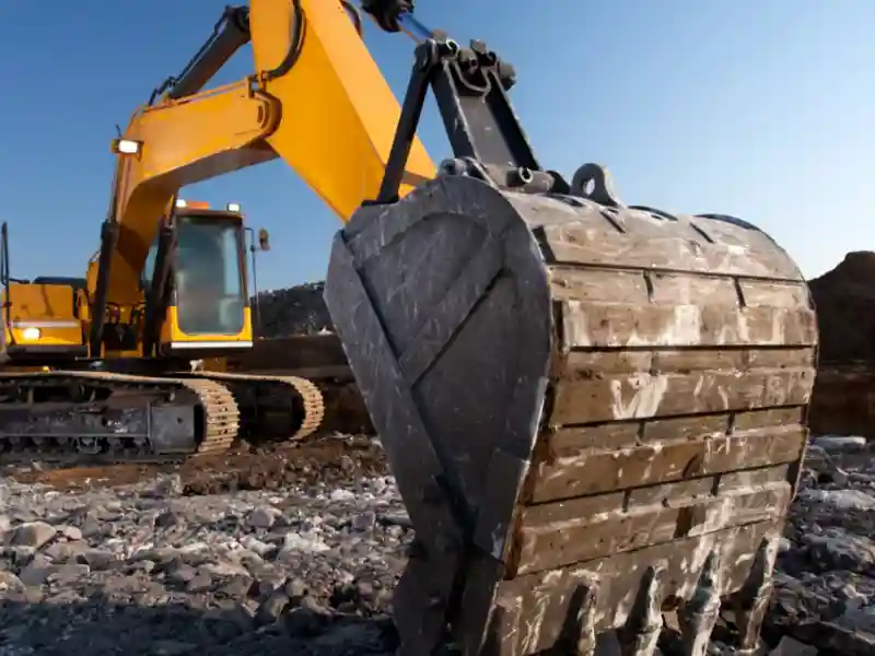 yellow escavators working on a mine
