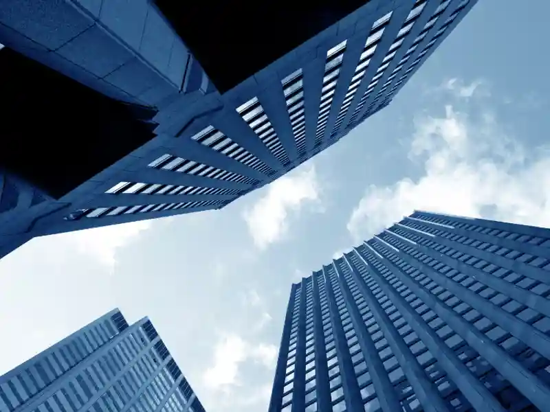 Looking up at city buildings from the street.
