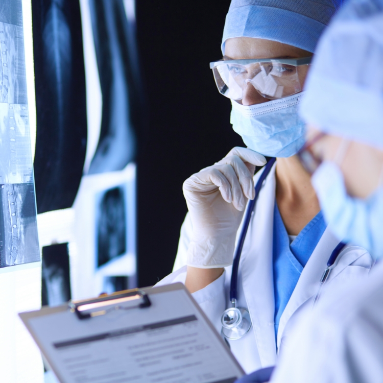 Two female women medical doctors looking at x-rays in a hospital