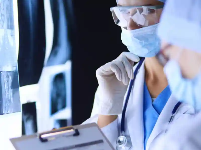 Two female women medical doctors looking at x-rays in a hospital