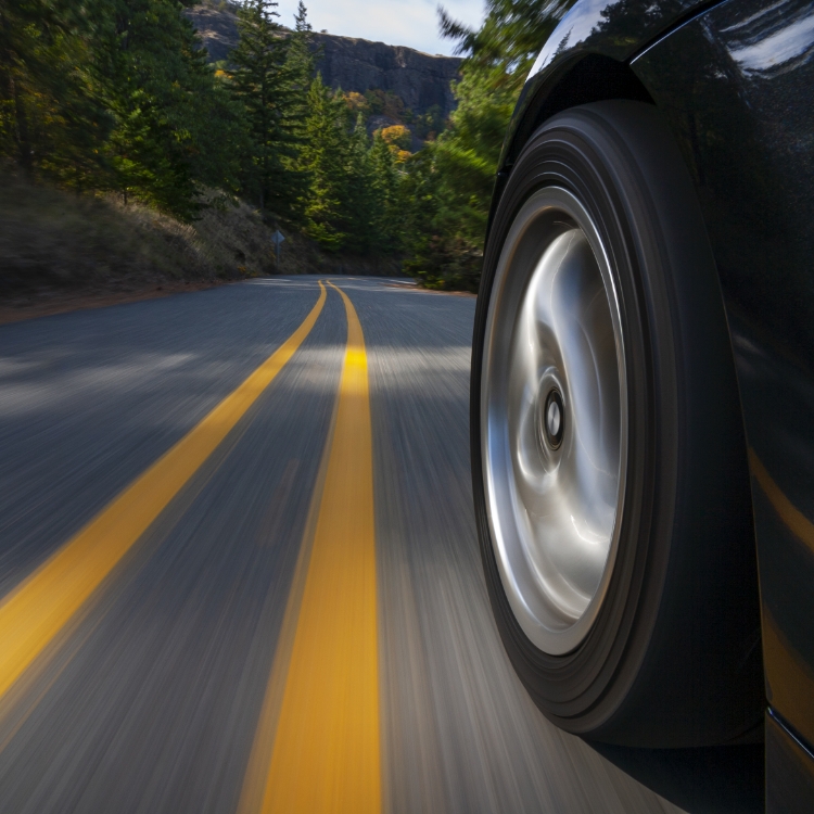 Black sports car motion country road.