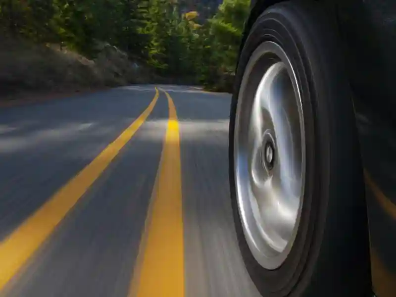 Black sports car motion country road.