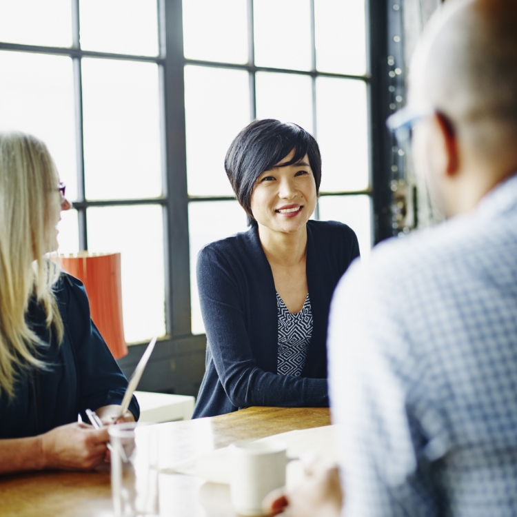 Businesswoman leading discussion with colleagues