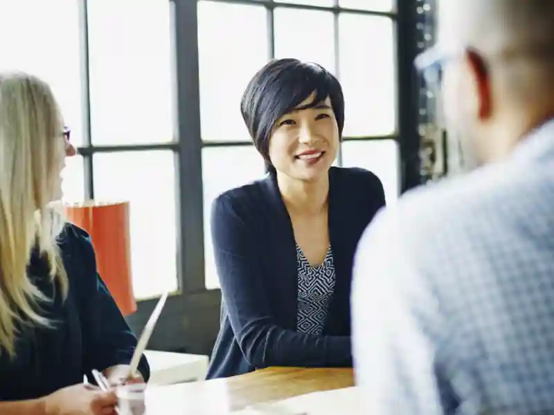 Businesswoman leading discussion with colleagues