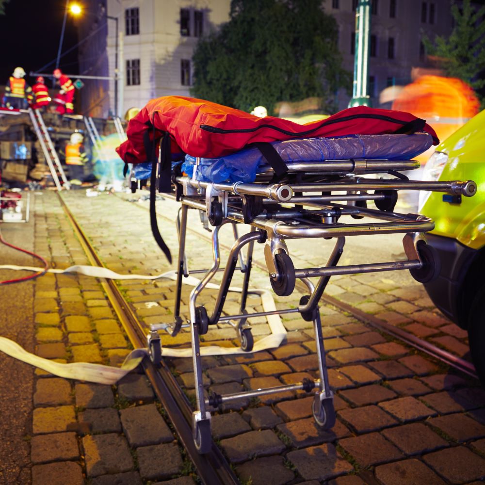EMS medical professionals on the site of an auto accident with a stretcher.